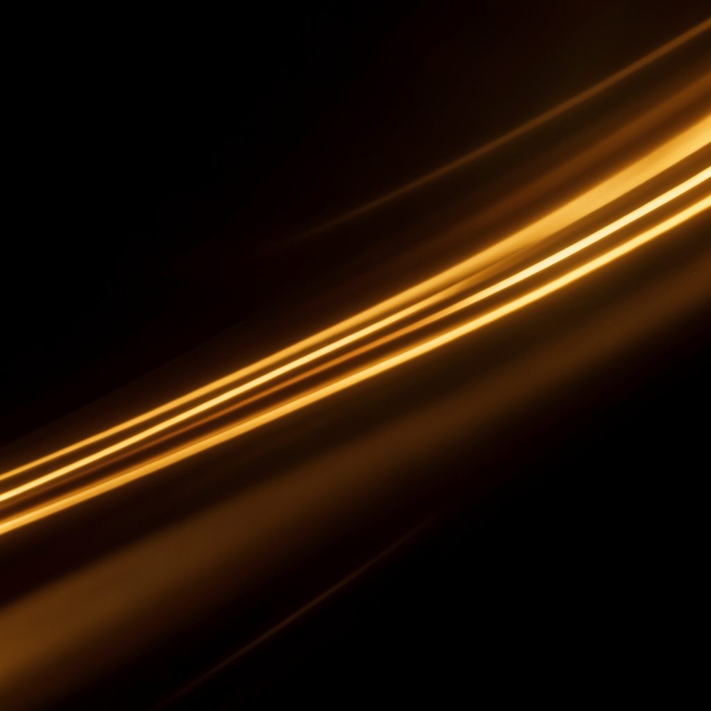 Warm amber and gold light streaks on a dark background, evoking high-speed connectivity